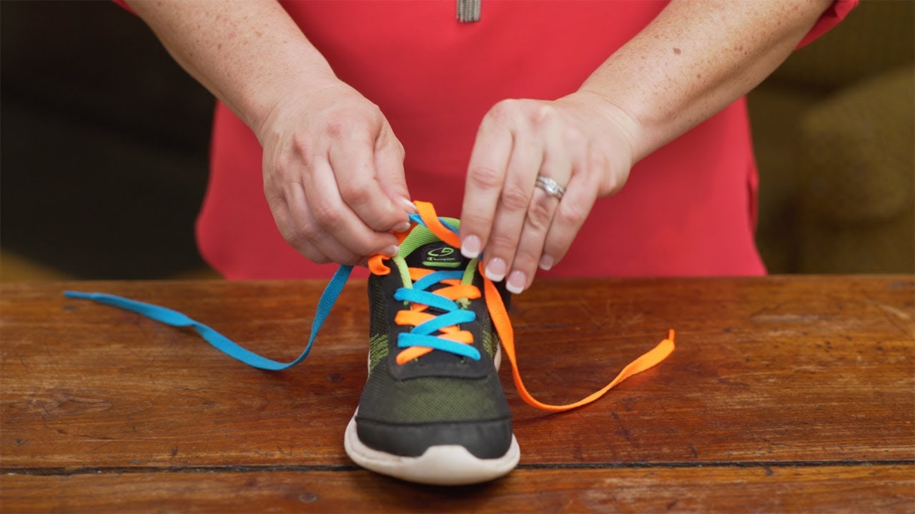 Woman preparing to tie shoe laces